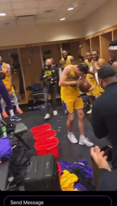 LeBron hands Reaves the game ball in the locker room