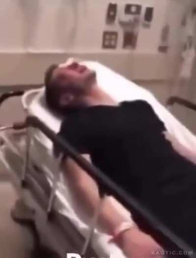 Police Officer protecting and serving the shit out of hospital patient.