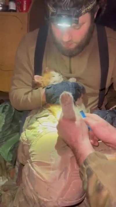 Ukrainian gives medical care to a cat while injured himself. This special operations unit has a veterinarian turned grenade launcher who is currently recovering from a bullet to the shoulder but he passed on his knowledge.
