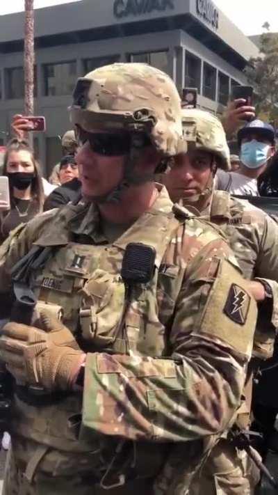 Armed National Guard troops taking a knee with George Floyd and BlackLivesMattter protestors on Hollywood Blvd: