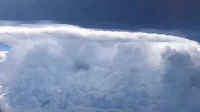 Timelapse of an aircraft passing by a storm system.