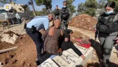 Jerusalem municipality wants to build a *Biblical theme park* on a 16th century Palestinian graveyard, police are trying to separate a mother from her child grave to make way for the bulldozers. Breaks my heart..