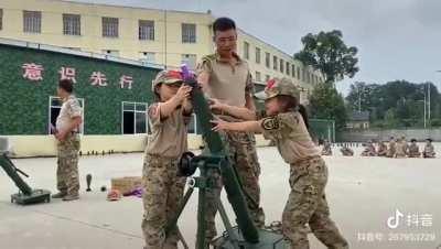 Chinese children get acquainted with a mortar.