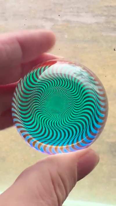 A 2 1/8” glass sphere made with dichroic glass, ink and borosilicate glass. This was cold worked. No heat.
