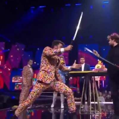 HMC a lady holds a flamethrower in the wrong direction at a Belgian TV show