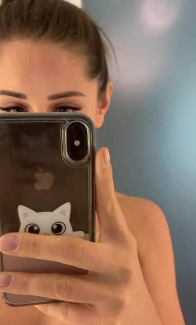 Showing herself off in the mirror 