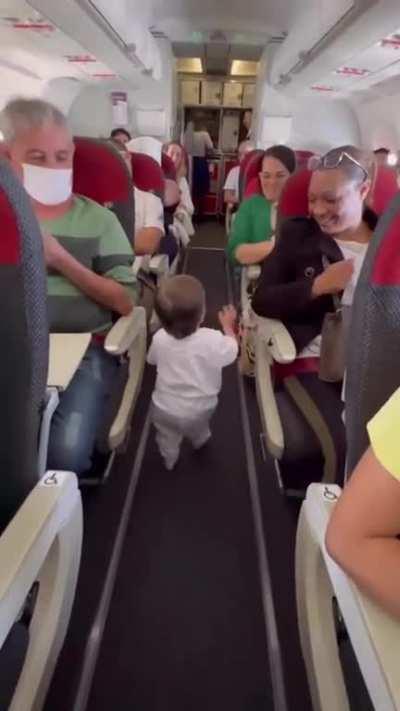 Little guy shaking hands with everyone in the plane