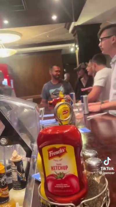 Woman squirts ketchup over two guy’s faces