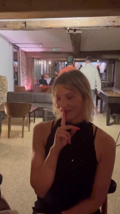 Sitting in a crowded bar wearing a facial