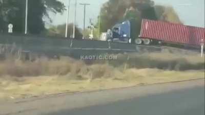 Semi stalled on the railroad tracks gets taken for a joyride. The driver is fine. He got out.