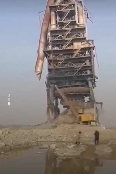 Towering, rusted blast furnace brought down with wrecking ball