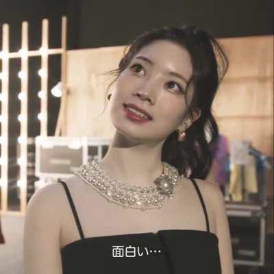 Dahyun in her Perfect World black dress and high ponytail