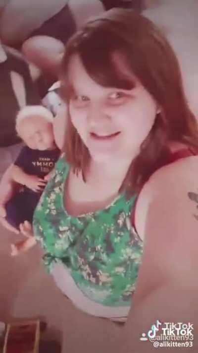 the baby isnt real and her verging on immobile husband is in a VR head set. this is our future.