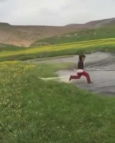 The kid trying to throw a net