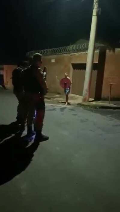 A drunk man challenging Police Officers using an axe and a shield