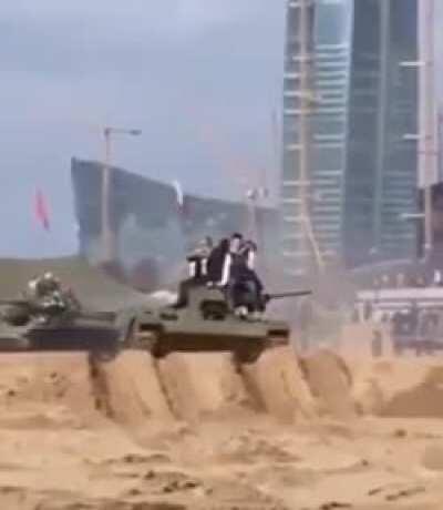 Sitting on top of a tank.