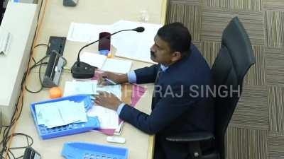 Election officer tampering with votes realizes that there's a CCTV camera right above him