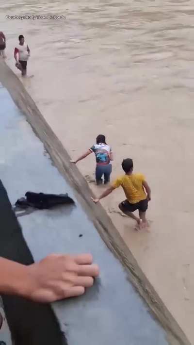 Teachers in a remote town in the Philippines, risk crossing a raging river after the typhoon washed away their only bridge.