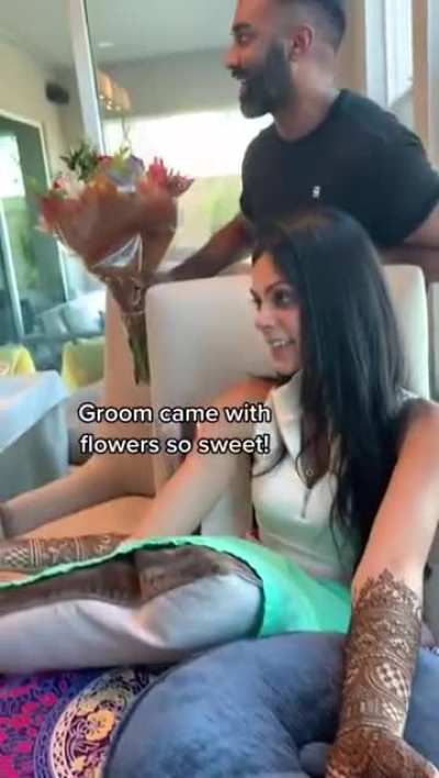 Intricate henna being applied for a bride