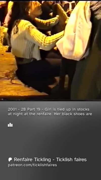 Girl is tied up in stocks at night at the renfaire.  Her black shoes are taken off and toes tied to the stocks.  Loves tickling