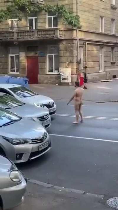 Naked guy walks in middle of road, against traffic, expecting vehicles to get out of his way - What could possibly go wrong?