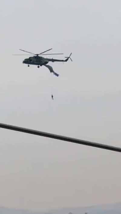 His parachute got stuck on the helicopter