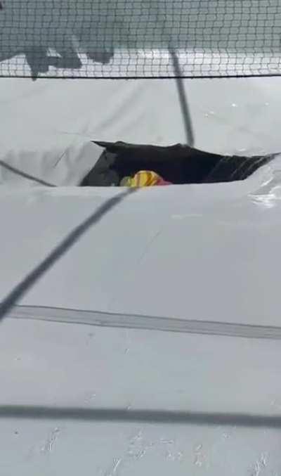 A sinkhole opens under a pool, 2 pepole swallowed in (one injured, the second missing)