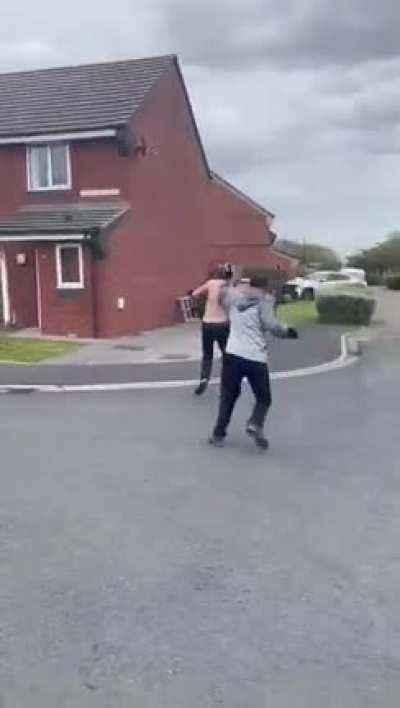 Two guys fighting with machetes.