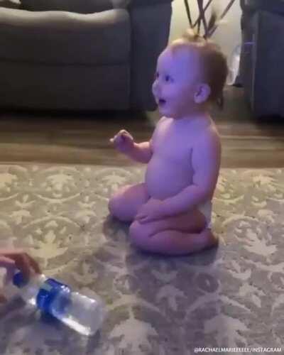 This adorable baby hitting a flawless bottle flip
