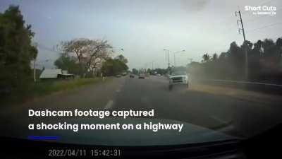 Truck spins out and flips over after tyre explodes on highway 