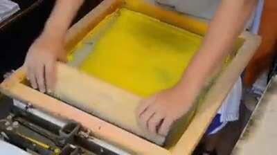 Screenprinting a color image onto a t-shirt.
