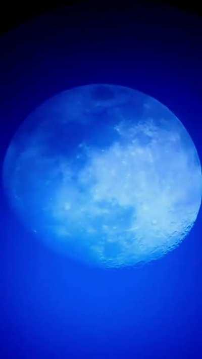 Evening Moon behind a thin cirrus cloud layer