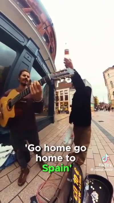 British Belfastman shouts at Spanish Busker to leave Northern Ireland because he's a Catholic and because the Busker politely told him he cannot play and talk at the same time 