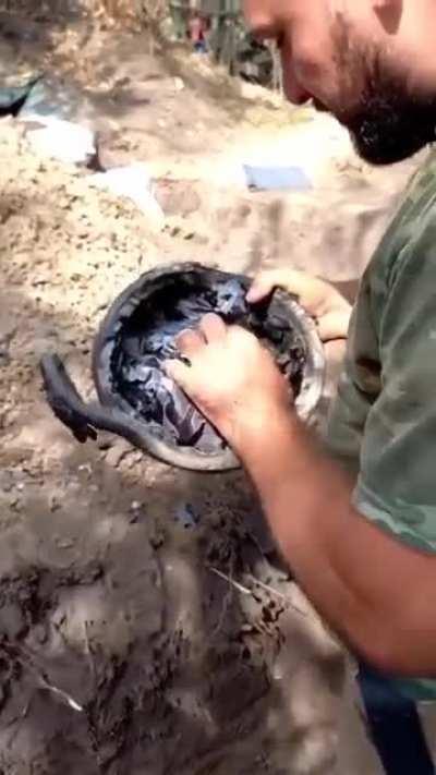 Ukrainian soldiers test a Russian 6B47 helmet captured in combat