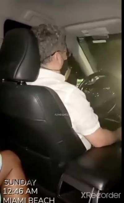 Woman has her finger on the trigger while riding a Lyft