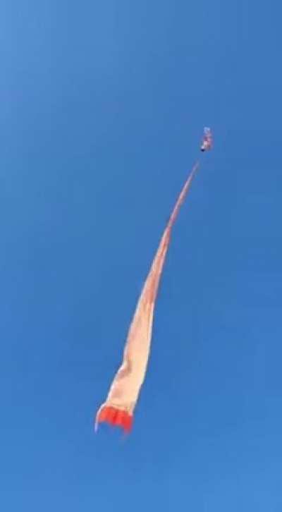 Small child gets carried up into the air with a kite