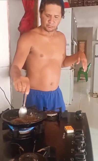 Frying food shirtless near a hot gas stove
