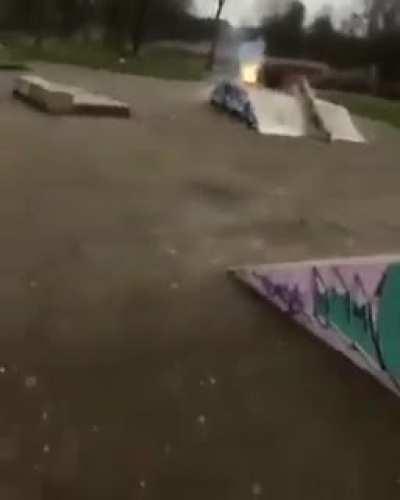 Guy lights fire in between bottles filled with flammable liquid