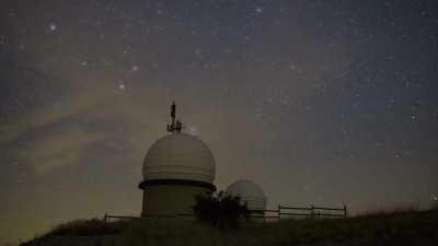 Rise of the Pleiades accompanied of a big meteor above the Observatory