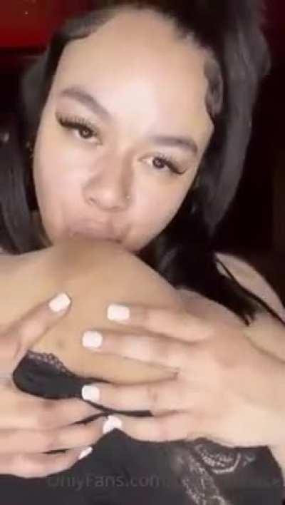 Sucking her own boobs