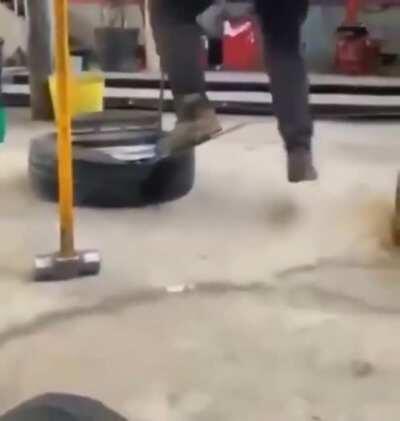Attempting to remove a tire.