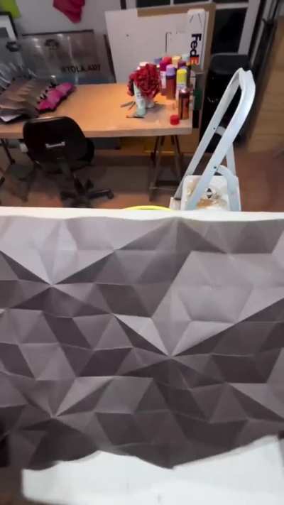 Paper folds turned into textured art with spray paint