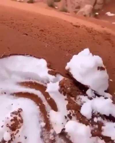 Sand covered snow in the desert in Saudi Arabia is making me hungry