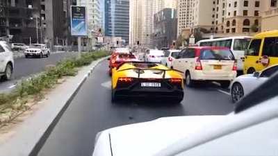A Lamborghini driver set his car on fire while roaring his engine in a traffic light