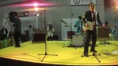 Bassist makes sweet jump, kicks shoe into crowd, crowd politely returns shoe, concert continues without incident.