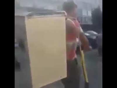 Guy riding a scooter with a stove with speakers on his back