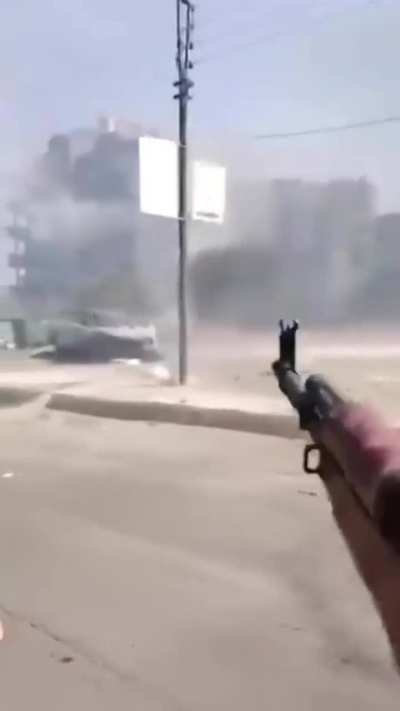 pov phone camera recording from a tribal militant’s vest shows a fighter shooting what looks like an RPG style rocket launcher, then the filming person shoots their rifle towards rival positions (druze in the building). recorded on the morning of saturday