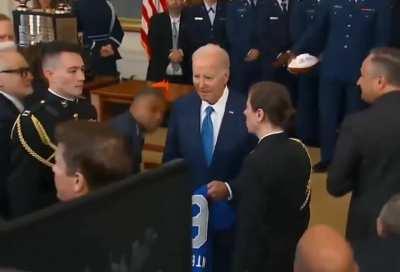 Joe Biden hosted the football team today! He was to be presented with a ball signed by the team, a helmet and a football jersey with his name on it. But Biden grabbed only a sweater and began to wander, looking for a way out. -Dementia?-