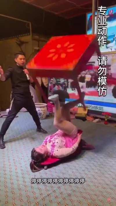 Lady rotating a pot and a table with her feet