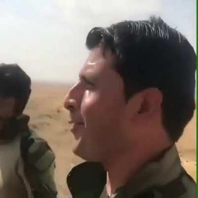 Kurdish peshmerga forcing two captured isis pow to carry the corpse of their dead mate.